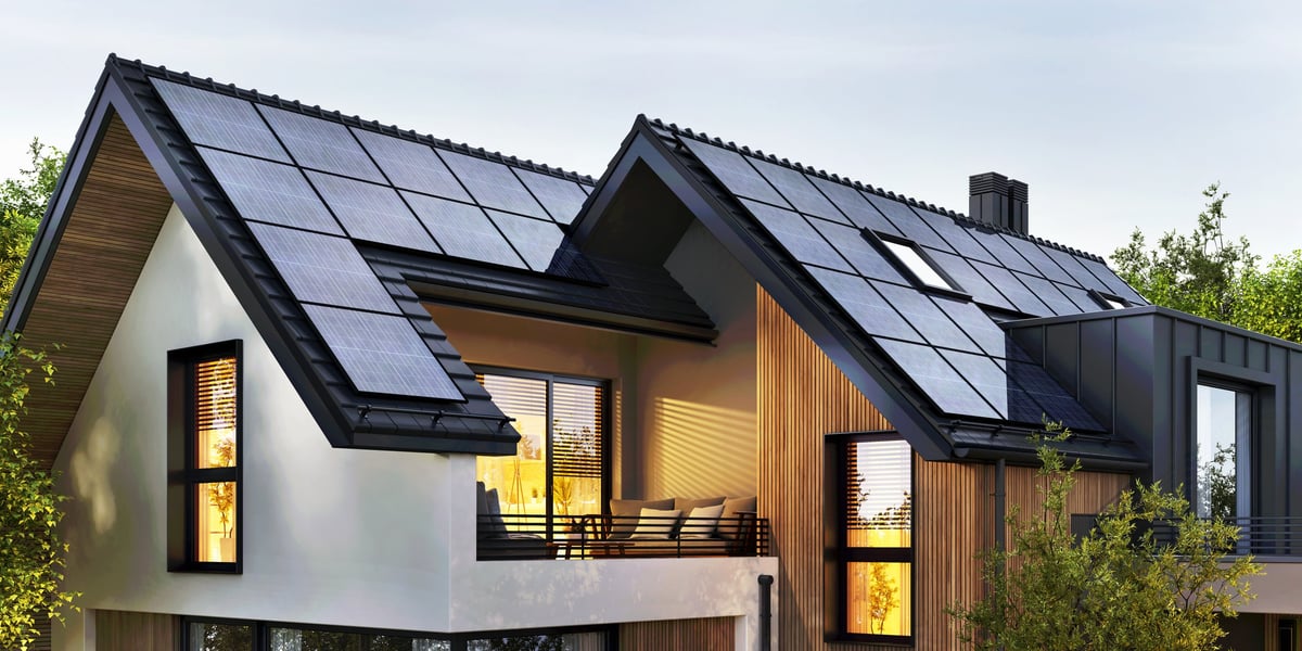 Modern UK home with black solar panels on the roof