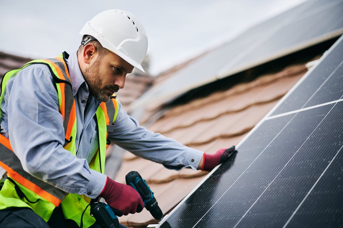 Solar installer working on a residential rooftop